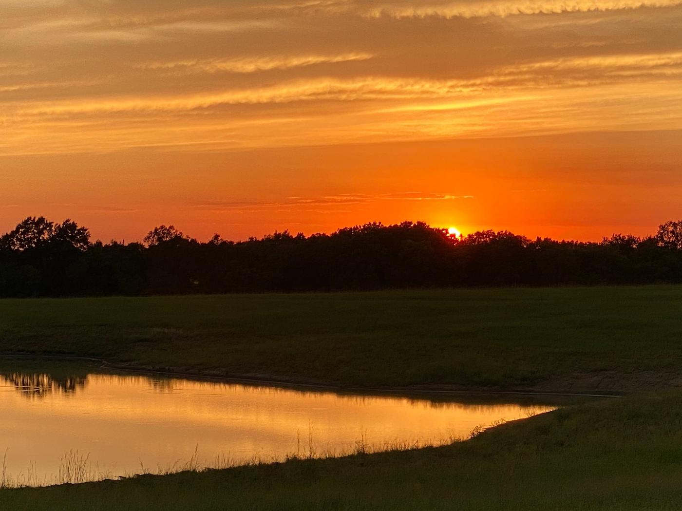 Sunset over the private pond at Wilderness Ranch